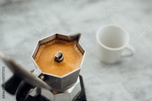 Moka pot with coffee and cup photo