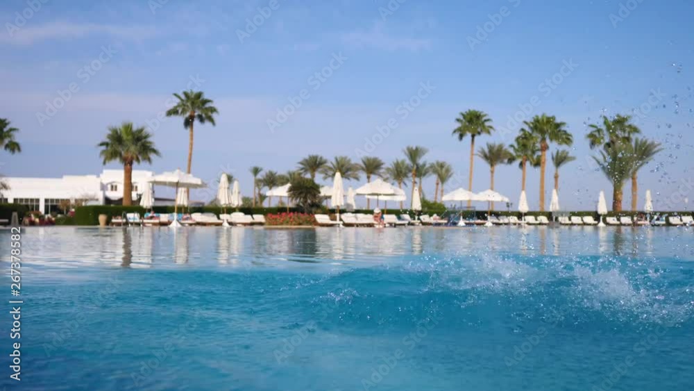 Man Jumping And Diving In Swimming Pool At Hotel Man Jumping And Diving In Swimming Pool At Hotel