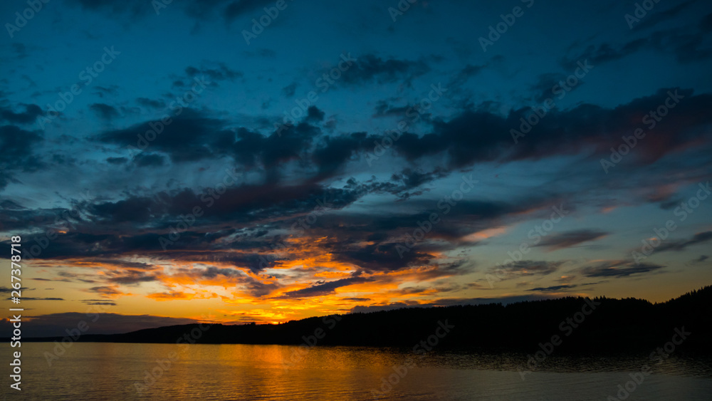 Dramatic colorful sunset on the river. Nature concept