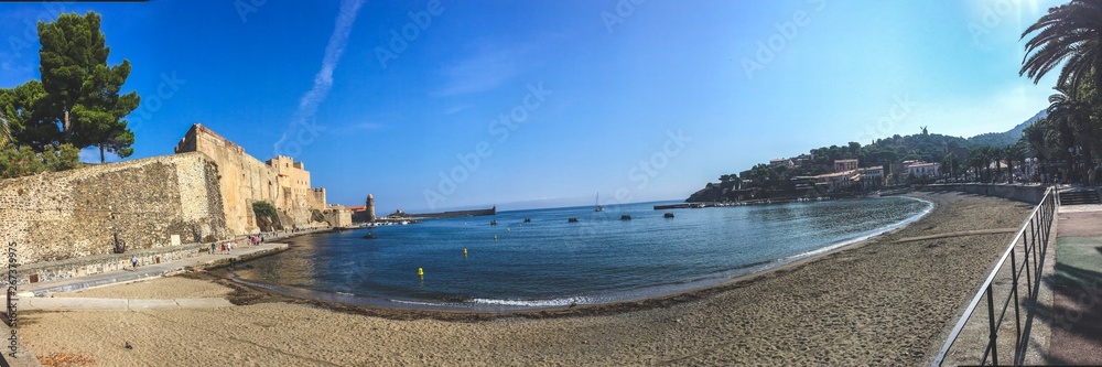 background panoramic view of the embankment of Collioure, the bay of the Mediterranean Sea and the medieval castle on the coast, Languedoc-Roussillon province, South France