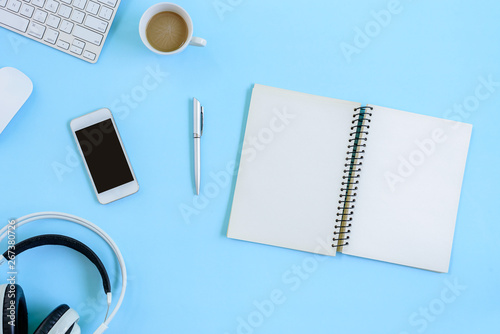 The office blue desk and equipment for working with coffee in top view and flat ray concept.