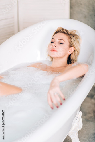 Blonde woman relaxing in bath