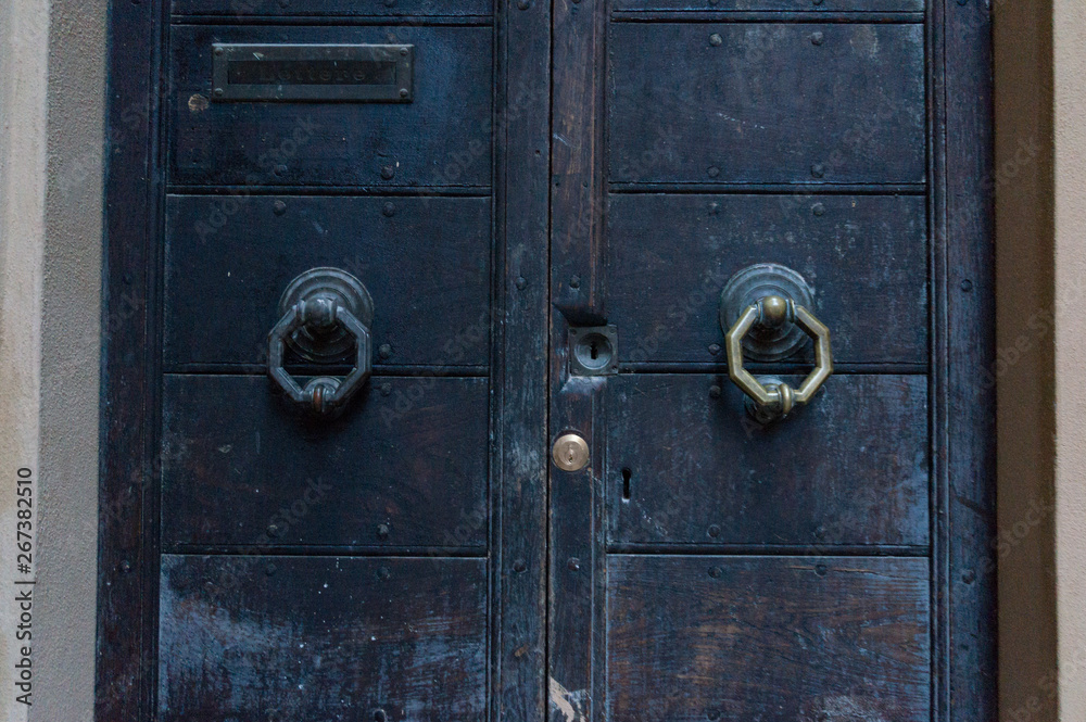 Close up of closed heavy wooden doors with octagon door handle Close up of closed heavy wooden doors with octagon door handle
