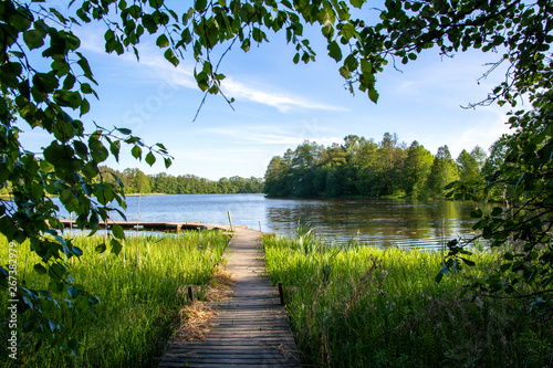 Photo Summer view to the river Mustio and wooden walkway from the Mustion Linna park,