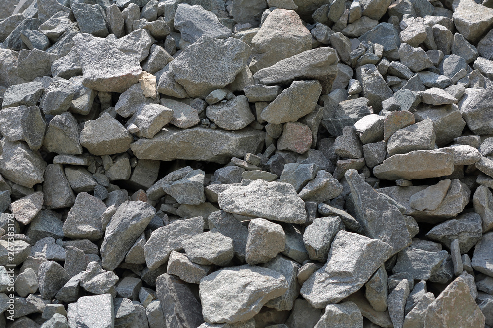 Gray textured surface of a heap of construction pebbles and gravel Gray textured surface of a heap of construction pebbles and gravel