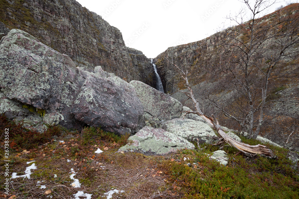 Mounitain with waterfall in the background in a national park in sweden photographed in late autumn