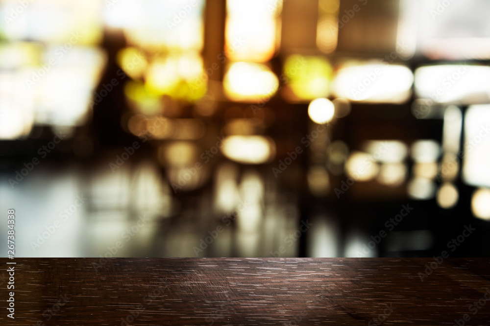 top of black table wood with blur light in bar or restaurant with soft light background
