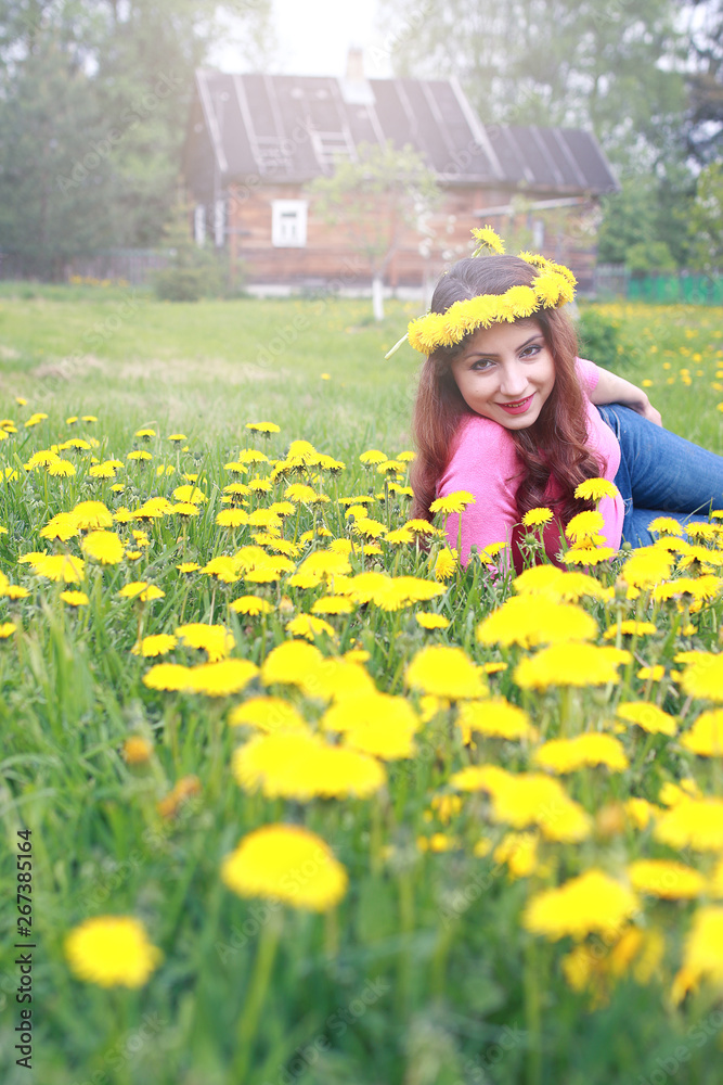 girl resting on a sunny day in meadow of yellow dandelions girl resting on a sunny day in meadow of yellow dandelions