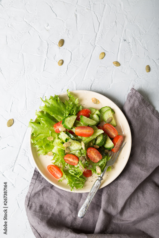 Simple vegetable salad on a light background Simple vegetable salad on a light background