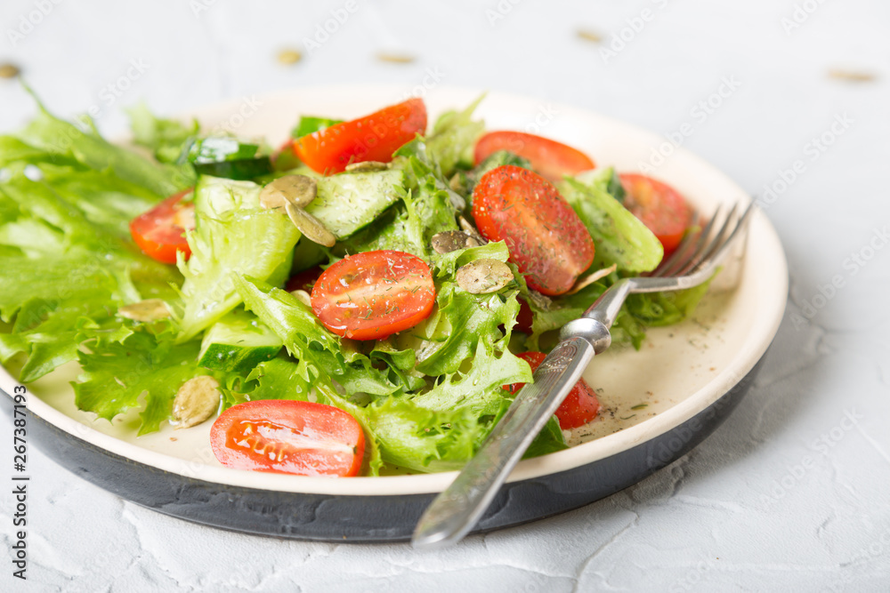 Simple vegetable salad on a light background Simple vegetable salad on a light background
