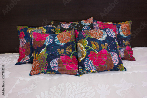 Dark Blue ethnic flower pattern cushions on bed
