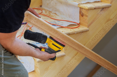 Installation for wooden railing for stairs grinder work on timber wood railings installation. photo