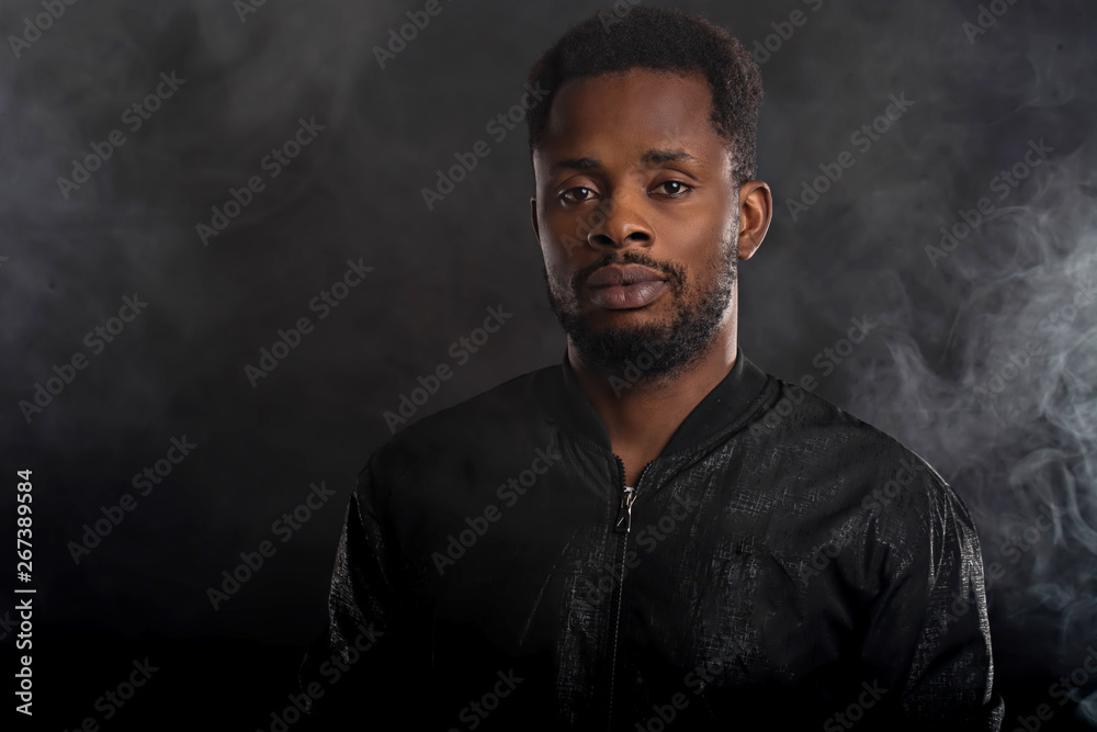 Portrait of handsome young African man on black background Portrait of handsome young African man on black background