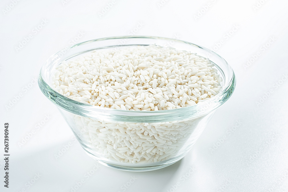 Glass bowl filled with a bowl of white glutinous rice on a white background Glass bowl filled with a bowl of white glutinous rice on a white background