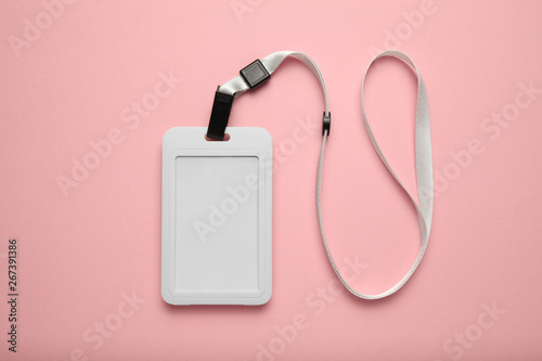 Blank badge mockup on pink background. Plain empty name tag mock up hanging on neck with white string.