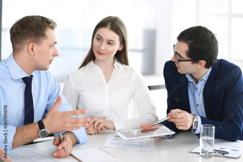 Group of business people discussing questions at meeting in modern office. Managers at negotiation or brainstorm. Teamwork, partnership and business concept Group of business people discussing questions at meeting in modern office. Managers at negotiation or brainstorm. Teamwork, partnership and business concept
