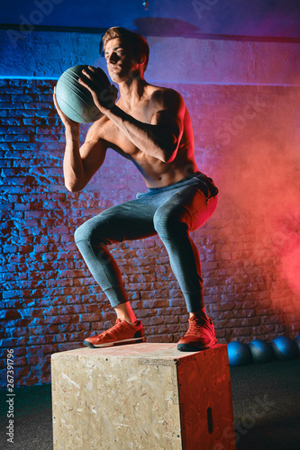 Obraz na plátně Man doing Box jumps adds a good dose of virtuosity for increased speed, efficiency and grace, like in any CrossFit movement