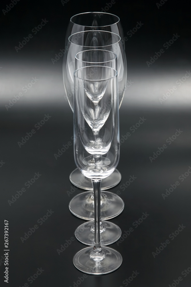 Four wine glasses on a dark background close up