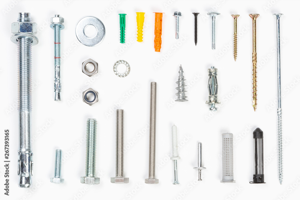 Top view of assorted materials carpenters use like screws, bolts, fixings, nuts screws and nails on a white background. Top view of assorted materials carpenters use like screws, bolts, fixings, nuts screws and nails on a white background.