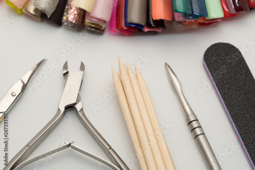 Manicure tools on a white background. Scissors, nail file, sticks, etc.