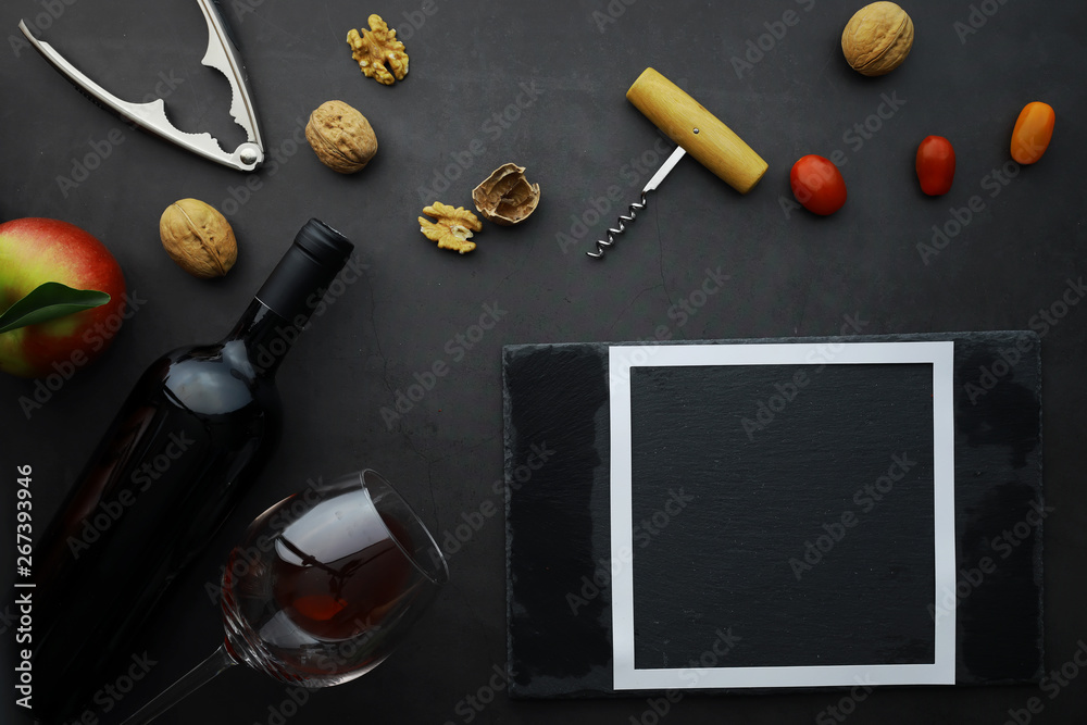 Wine glass and black wine bottle. Nuts cheese and tomatoes for snack. Wine glass and black wine bottle. Nuts cheese and tomatoes for snack.