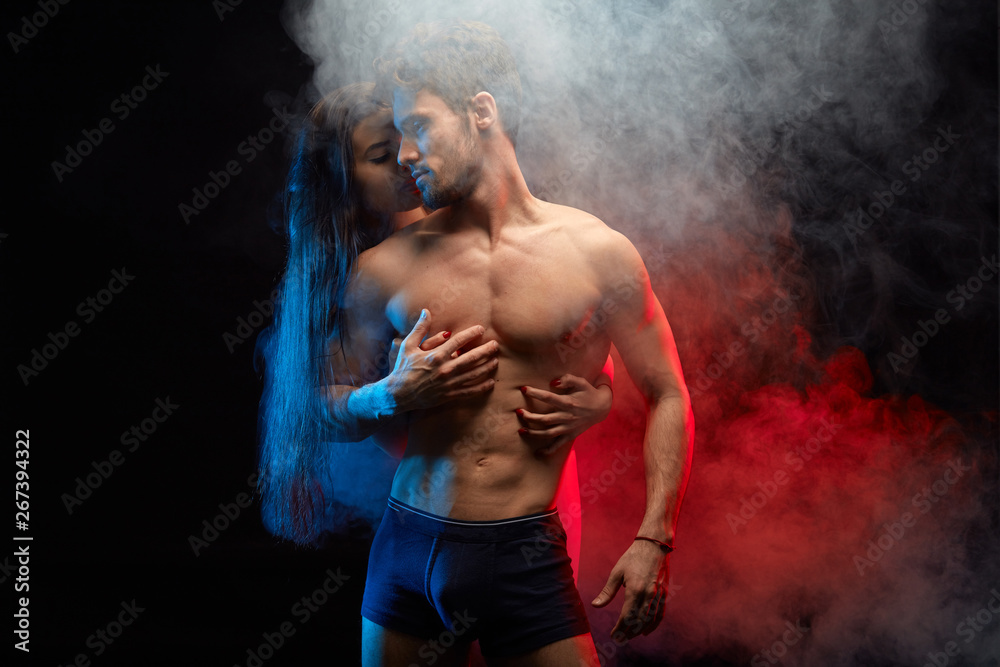 intimate romantic couple playing in love games. close up photo. isolated black background