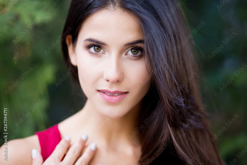 Close up outdoor portrait of young beautiful brunette woman with green eyes and long healthy hair. Close up outdoor portrait of young beautiful brunette woman with green eyes and long healthy hair.