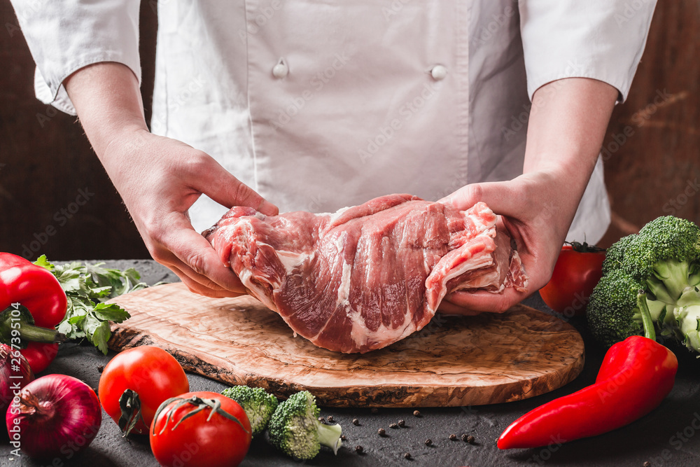 Hands Chef Butcher holdind pork meat on kitchen, cooking food