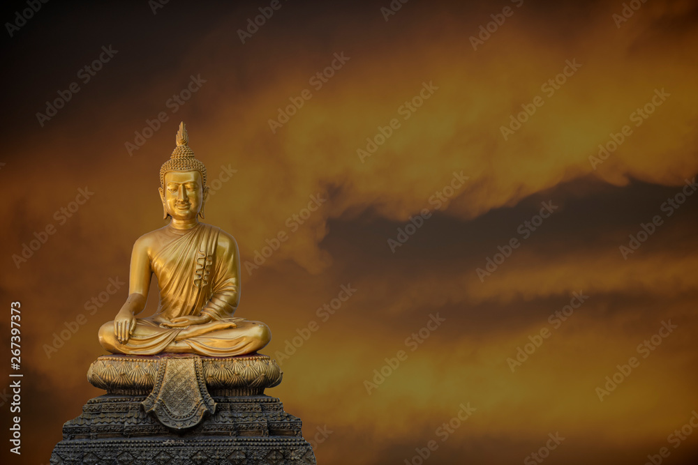 A peaceful superimposed and double exposure images of Golden Buddha statue from Wat Pathum Wanaram, Bangkok, Thailand and pink clouds. Buddha statue is posing “The attitude of subduing Mara