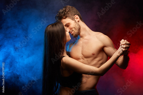 heterosexual topless couple enjoying dance in the smoky studio. close up photo.entertainmnet, warm feeling