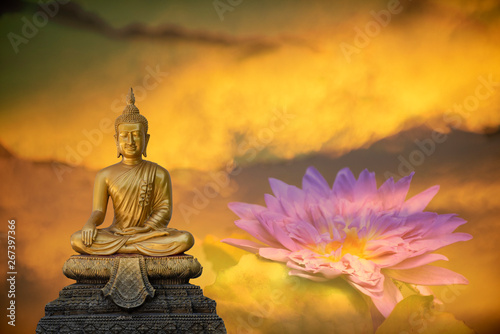 A peaceful superimposed and double exposure images of Golden Buddha statue from Wat Pathum Wanaram  Bangkok  Thailand and pink clouds. Buddha statue is posing    The attitude of subduing Mara .