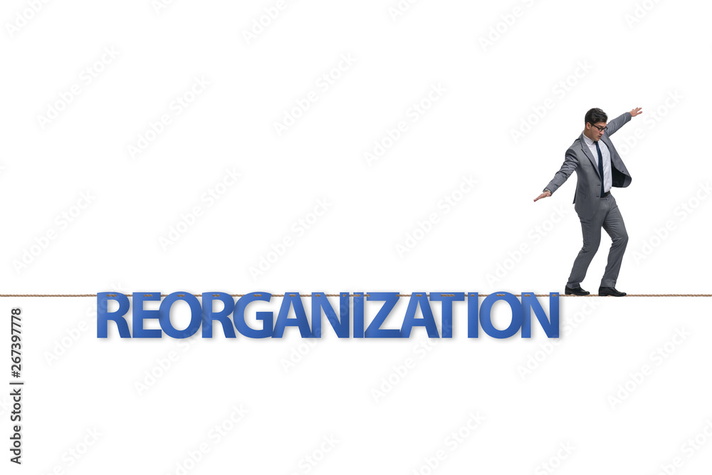 Reorganisation concept with businessman walking on tight rope Reorganisation concept with businessman walking on tight rope