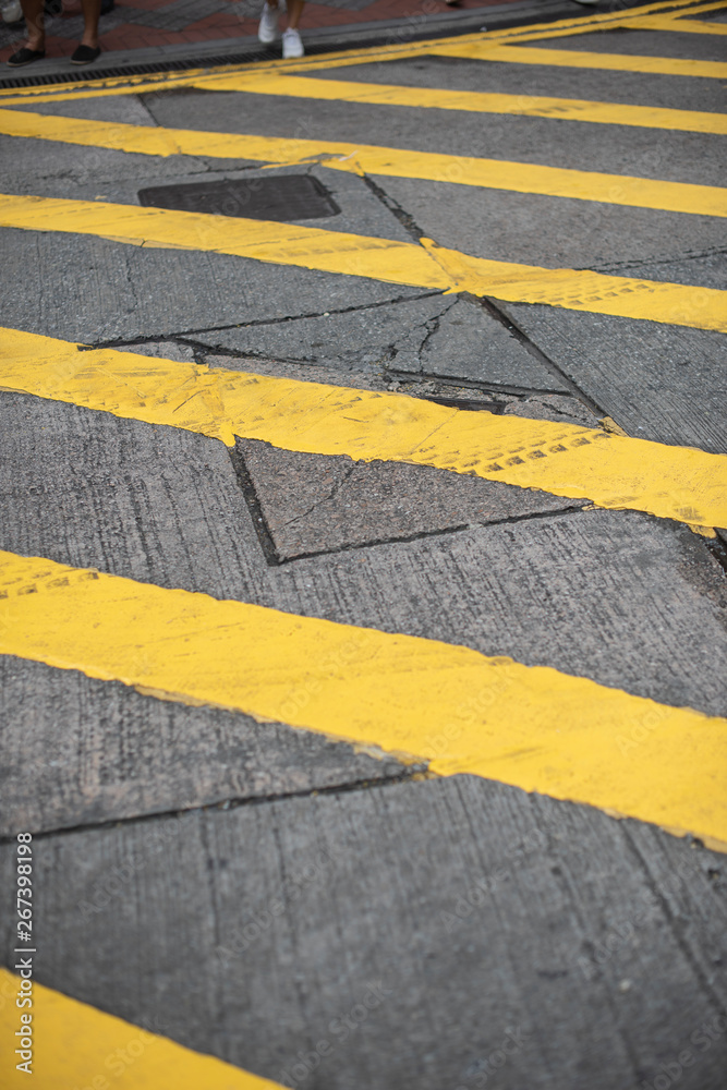 Fototapeta premium Yellow lines painted on the road, showing traffic rules guide for drivers and pedestrians to follow the laws.