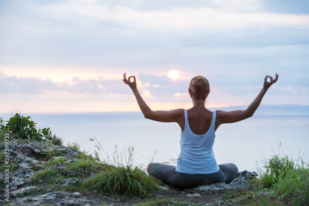 Caucasian woman practicing yoga at seashore Caucasian woman practicing yoga at seashore