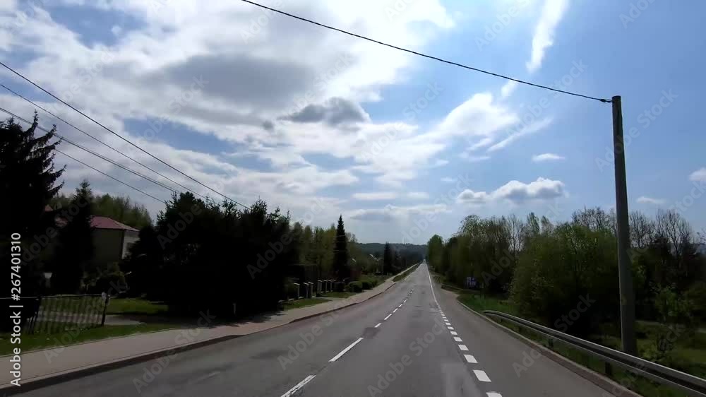 A straight village road in the mountains without traffic. A straight village road in the mountains without traffic.