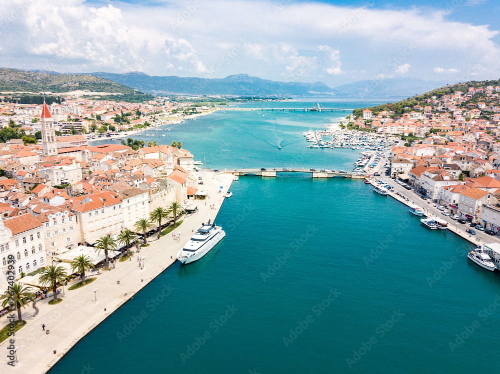 Aerial view of touristic old Trogir, historic town on a small island and harbour on the Adriatic coast in Split-Dalmatia County, Croatia. Ciovski most connects Ciovo and Trogir islands. Kastela gulf