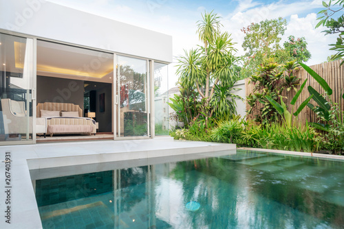 home or house building Exterior and interior design showing tropical pool villa with green garden and bedroom © Stock PK