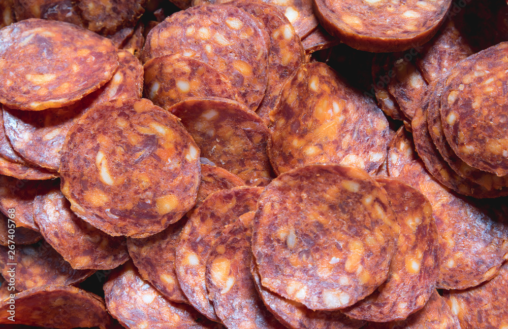 Pepper salami, Dried red tasty pepper salami or sausage rings snack food close up background with selective focus view from above