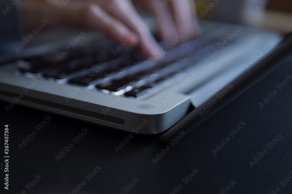 Blurry female's hand typing on laptop. Blurry female's hand typing on laptop.