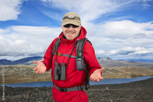 Happy tourist with backpack is traveling in the highlands