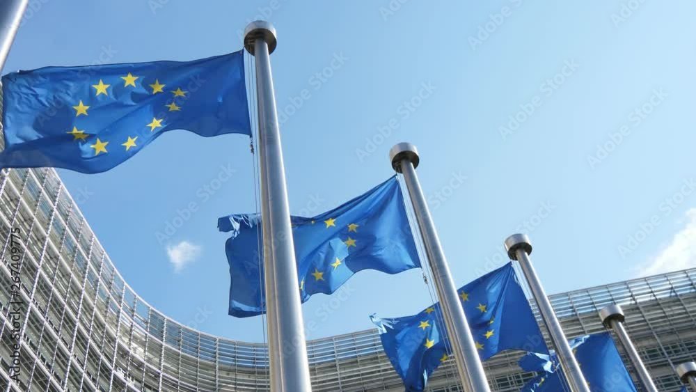 Glorious EU flags flying at the European Parliament in spring in slow motion 