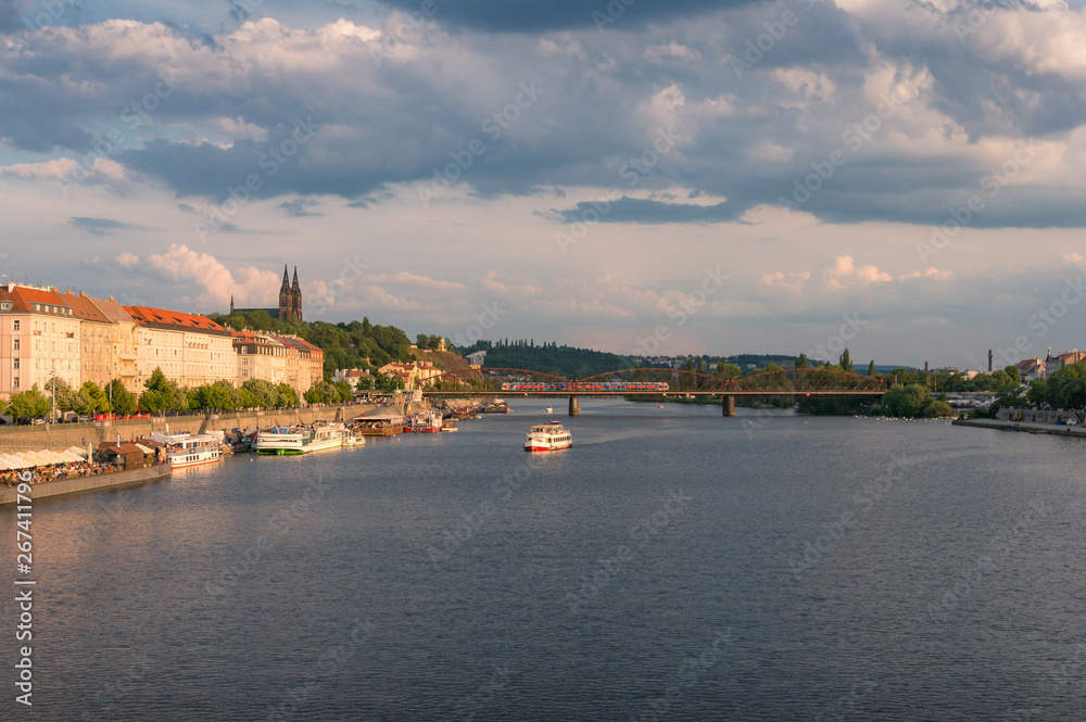 Prague cityscape with cruise boat on Vltava river
