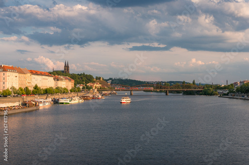 Prague cityscape with cruise boat on Vltava river © Olga K