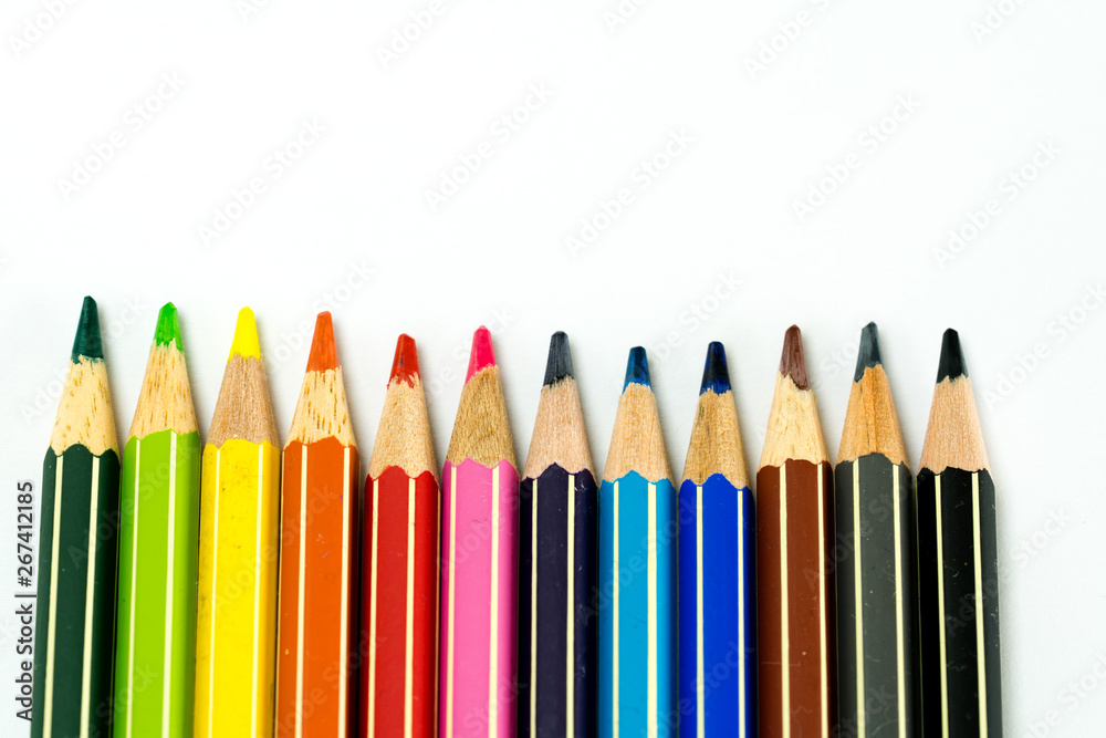 row of colored pencils on a white background row of colored pencils on a white background