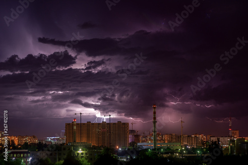 Stormy sky with flashes over night city