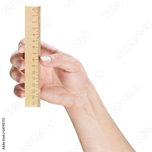 Hand holding a wooden ruler, isolated on white background