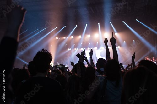 hands to the skies of people dancing and having fun at the live music concert