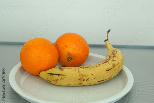 Fruit served on the tray and photographed on white plate