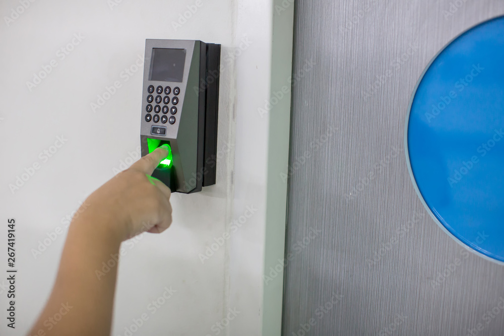 Finger scan on machine Security concept and safety. soft focus on hand scanning finger on machine concept. Businessman hand scanning finger on machine,Technology concept or Business concept. Finger scan on machine Security concept and safety. soft focus on hand scanning finger on machine concept. Businessman hand scanning finger on machine,Technology concept or Business concept.
