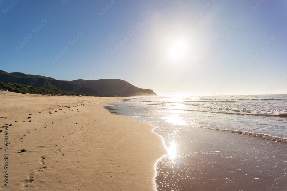 Beach landscape with soft waves and bright sunshine